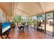 Relaxing sunroom with tiled flooring, outdoor views, and ample seating for entertaining at 3053 Monica Pkwy, Sarasota, FL 34234