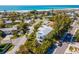 Aerial shot of the neighborhood and the beautiful beaches and Gulf in the background at 306 Poinsettia Rd, Anna Maria, FL 34216