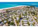 Breathtaking aerial view of homes near a pristine beach with crystal-clear turquoise waters at 306 Poinsettia Rd, Anna Maria, FL 34216