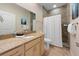 Bathroom featuring a vanity with granite countertop, and a walk-in shower with a curtain at 306 Poinsettia Rd, Anna Maria, FL 34216