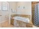 Bright bathroom showcasing a jacuzzi tub and separate shower at 306 Poinsettia Rd, Anna Maria, FL 34216