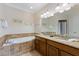 Bathroom with double sink, jacuzzi tub, and tiled shower at 306 Poinsettia Rd, Anna Maria, FL 34216