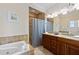 Bathroom featuring jacuzzi tub, shower, and double sinks at 306 Poinsettia Rd, Anna Maria, FL 34216