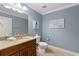 Bathroom featuring a granite vanity, toilet, mirror, and tiled floors at 306 Poinsettia Rd, Anna Maria, FL 34216
