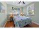 Cozy bedroom with natural light, hardwood floors, and tropical themed décor at 306 Poinsettia Rd, Anna Maria, FL 34216