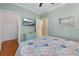 Bright bedroom with a TV, coastal decor, and closet space at 306 Poinsettia Rd, Anna Maria, FL 34216