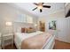 A well-lit bedroom with neutral tones, hardwood floors, and a view of an en-suite bathroom at 306 Poinsettia Rd, Anna Maria, FL 34216