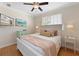 A charming bedroom with hardwood floors, a TV, two beds, and cozy decor at 306 Poinsettia Rd, Anna Maria, FL 34216
