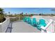 Deck with light blue Adirondack chairs overlooking the beach, perfect for relaxation and enjoying ocean views at 306 Poinsettia Rd, Anna Maria, FL 34216