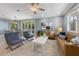 Open-concept living room with a dining area featuring a wooden table, wood chairs and backyard access at 306 Poinsettia Rd, Anna Maria, FL 34216