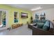 Game room with cozy seating, TV, and natural light, perfect for entertainment and relaxation at 306 Poinsettia Rd, Anna Maria, FL 34216