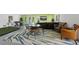 Spacious game room boasts a mini golf area, foosball table, entertainment area and tropical themed decor at 306 Poinsettia Rd, Anna Maria, FL 34216