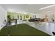 Expansive game room featuring a mini golf area, foosball table, a TV and comfortable seating at 306 Poinsettia Rd, Anna Maria, FL 34216