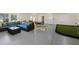 Open-concept game room with seating, mini golf, and a refrigerator, designed for entertainment and relaxation at 306 Poinsettia Rd, Anna Maria, FL 34216