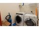 Laundry room equipped with modern washer and dryer units plus shelving at 306 Poinsettia Rd, Anna Maria, FL 34216