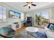 Living room with entertainment center, arcade machine, and access to outdoor seating at 306 Poinsettia Rd, Anna Maria, FL 34216
