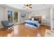 Stylish main bedroom with balcony access, hardwood floors, and coastal decor at 306 Poinsettia Rd, Anna Maria, FL 34216
