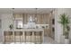 Stylish kitchen featuring stainless steel appliances, island seating, and modern cabinetry at 325 Golden Gate Pt # 1004, Sarasota, FL 34236