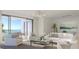 Bright, open living room with modern furnishings, balcony access, and breathtaking ocean views at 325 Golden Gate Pt # 1004, Sarasota, FL 34236
