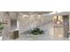 Modern condo lobby featuring a staircase, stone accents, and elegant decor at 325 Golden Gate Pt # 1004, Sarasota, FL 34236