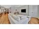 Bright, open-concept living room features a plush white sofa and flows seamlessly into the modern kitchen space at 3533 Secluded Ct, Sarasota, FL 34240