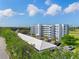 Aerial view of the building and covered parking near the golf course at 3790 Pinebrook Cir # 408, Bradenton, FL 34209