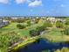 Scenic aerial view of a community featuring a golf course and lakes at 3790 Pinebrook Cir # 408, Bradenton, FL 34209