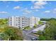An aerial view showing the condo building, parking lot, and surrounding landscaping at 3790 Pinebrook Cir # 408, Bradenton, FL 34209