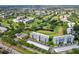 Aerial view of community featuring lush landscaping, swimming pool, a golf course and multiple residential buildings at 3790 Pinebrook Cir # 408, Bradenton, FL 34209
