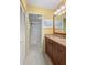Bathroom boasts granite countertops, a large mirror, and a shower with a glass door at 3790 Pinebrook Cir # 408, Bradenton, FL 34209