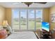 Bright bedroom with plantation shutters provides scenic views of the golf course at 3790 Pinebrook Cir # 408, Bradenton, FL 34209