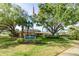 Pinebrook Clubhouse entrance with manicured lawn and mature trees at 3790 Pinebrook Cir # 408, Bradenton, FL 34209