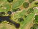 Aerial view of golf course with ponds, trees and manicured green grass at 3790 Pinebrook Cir # 408, Bradenton, FL 34209