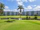 View of green golf course with pond and trees outside condo buildings at 3790 Pinebrook Cir # 408, Bradenton, FL 34209