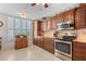 Functional kitchen featuring stainless steel appliances, granite countertops, and classic wood cabinetry at 3790 Pinebrook Cir # 408, Bradenton, FL 34209