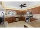 Kitchen features updated stainless steel appliances, tile backsplash and countertops, and a ceiling fan at 3790 Pinebrook Cir # 408, Bradenton, FL 34209