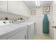 Efficient laundry room with washer, dryer, and ample storage space at 3790 Pinebrook Cir # 408, Bradenton, FL 34209