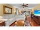 Open living room features hardwood floors, ceiling fan, and an eat-in kitchen with bar seating at 3790 Pinebrook Cir # 408, Bradenton, FL 34209