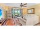 Bright living room features hardwood floors, a ceiling fan, and sliding doors to an enclosed lanai at 3790 Pinebrook Cir # 408, Bradenton, FL 34209