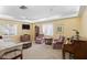 Comfortable living room with plush seating, large windows, and a classic piano for entertainment at 3790 Pinebrook Cir # 408, Bradenton, FL 34209
