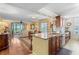 Open-concept space connects kitchen, dining, and living areas, featuring hardwood floors and natural light at 3790 Pinebrook Cir # 408, Bradenton, FL 34209