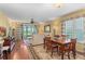 Cozy living space with a dining area, hardwood floors, and access to the outdoor balcony at 3790 Pinebrook Cir # 408, Bradenton, FL 34209