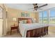 Bedroom offers a ceiling fan and lovely views of the golf course through plantation shutters at 3790 Pinebrook Cir # 408, Bradenton, FL 34209