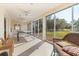 Bright sunroom with ceiling fans, sliding glass doors, ping pong table, and comfortable wicker chaise lounge at 3790 Pinebrook Cir # 408, Bradenton, FL 34209