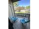 Relaxing screened balcony with chairs and a view of lush landscaping at 4005 Crockers Lake Blvd # 11, Sarasota, FL 34238