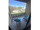 Relaxing screened balcony with chairs and a view of lush landscaping at 4005 Crockers Lake Blvd # 11, Sarasota, FL 34238