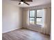 Bedroom featuring a ceiling fan, wood-look floors, and a window with neutral curtains at 4005 Crockers Lake Blvd # 11, Sarasota, FL 34238
