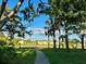 Scenic view of community with a walking path, picturesque lake, and well-maintained buildings at 4005 Crockers Lake Blvd # 11, Sarasota, FL 34238