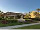Clubhouse exterior surrounded by mature trees, well-manicured lawns, and beautiful fountain at 4005 Crockers Lake Blvd # 11, Sarasota, FL 34238