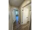 Hallway view showcasing bedrooms, bath, hardwood floors, and freshly painted white walls at 4005 Crockers Lake Blvd # 11, Sarasota, FL 34238
